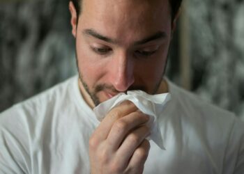man wiping mouse with tissue paper