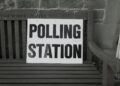 bench with polling station sign