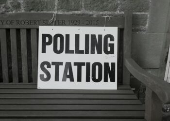 bench with polling station sign