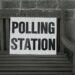 bench with polling station sign