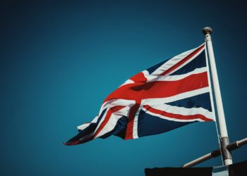 us a flag on pole under blue sky during daytime