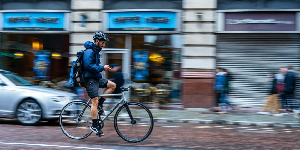 man riding bike on road