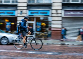 man riding bike on road