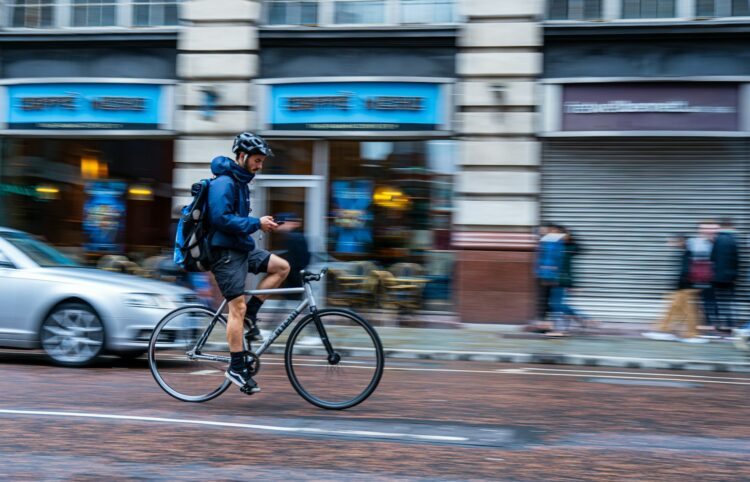 man riding bike on road