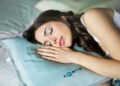 woman sleeping on blue throw pillow